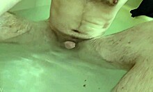 Hunk in the tub gets a gay bath massage